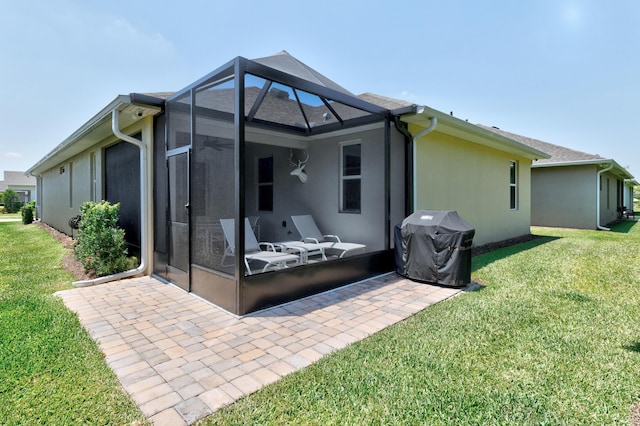 6020 Wild Olive Way, Vero Beach, FL 32966 - back of house featuring a patio area, a lawn, stucco siding, and a lanai