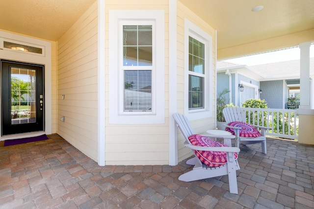 6020 Wild Olive Way, Vero Beach, FL 32966 - doorway to property featuring a porch