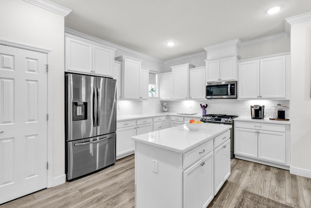 6020 Wild Olive Way, Vero Beach, FL 32966 - kitchen featuring stainless steel appliances, white cabinets, light wood-style floors, crown molding, and recessed lighting