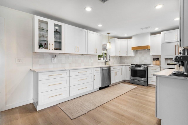 220 Fordham Dr, Lake Worth Beach, FL 33460 - kitchen featuring stainless steel appliances, white cabinetry, light countertops, light wood-type flooring, and recessed lighting