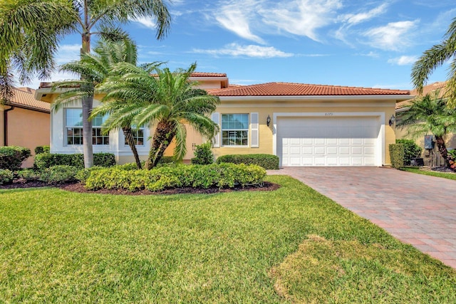 8273 Razorback Ct, Boynton Beach, FL 33473 - mediterranean / spanish house with driveway, a front yard, stucco siding, a garage, and a tile roof