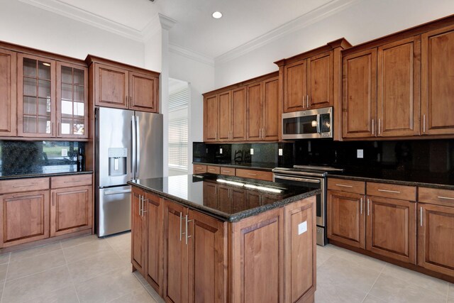 8273 Razorback Ct, Boynton Beach, FL 33473 - kitchen with stainless steel appliances, brown cabinetry, light tile patterned flooring, backsplash, and ornamental molding