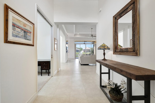 8273 Razorback Ct, Boynton Beach, FL 33473 - hallway featuring a raised ceiling, baseboards, and light tile patterned floors