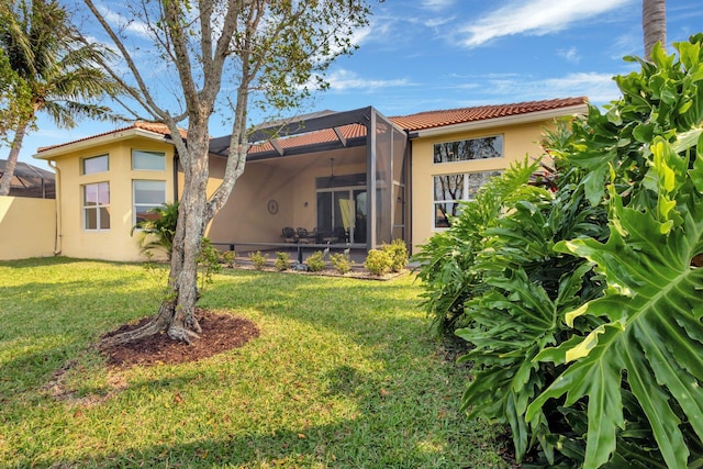 8273 Razorback Ct, Boynton Beach, FL 33473 - rear view of property with stucco siding, a lawn, a tile roof, and a lanai