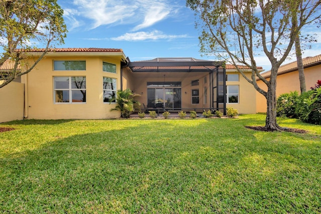 8273 Razorback Ct, Boynton Beach, FL 33473 - back of property with stucco siding, a yard, glass enclosure, and a tiled roof