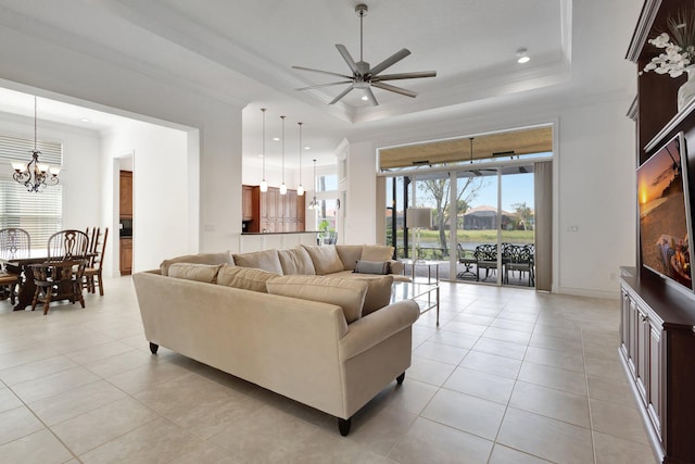 8273 Razorback Ct, Boynton Beach, FL 33473 - living room with a raised ceiling, a chandelier, a ceiling fan, light tile patterned flooring, and crown molding