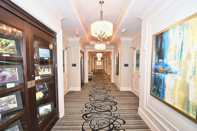 8273 Razorback Ct, Boynton Beach, FL 33473 - hallway featuring ornamental molding, a chandelier, dark colored carpet, and baseboards