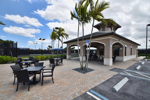 8273 Razorback Ct, Boynton Beach, FL 33473 - view of community with uncovered parking, outdoor dining space, and a patio area
