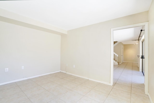 707 7th Ter, Palm Beach Gardens, FL 33418 - empty room with stairs and light tile patterned floors