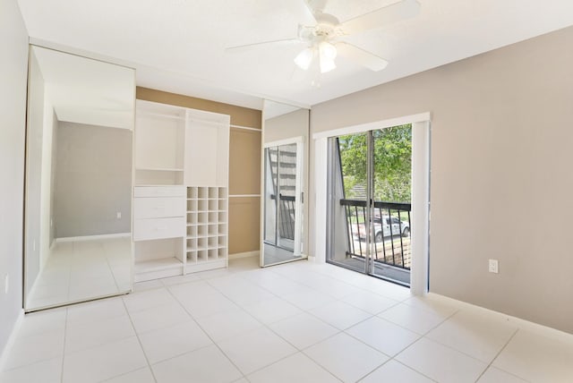 707 7th Ter, Palm Beach Gardens, FL 33418 - unfurnished bedroom featuring access to outside, light tile patterned flooring, baseboards, and ceiling fan