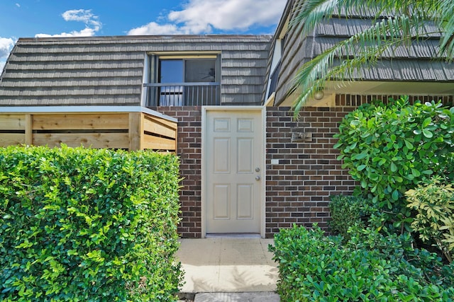 707 7th Ter, Palm Beach Gardens, FL 33418 - doorway to property with brick siding