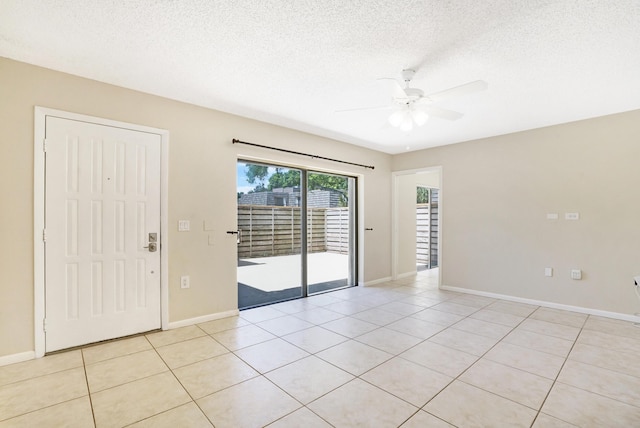 707 7th Ter, Palm Beach Gardens, FL 33418 - empty room featuring ceiling fan, light tile patterned flooring, baseboards, and a textured ceiling