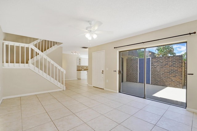 707 7th Ter, Palm Beach Gardens, FL 33418 - spare room featuring stairway, a ceiling fan, light tile patterned floors, and baseboards