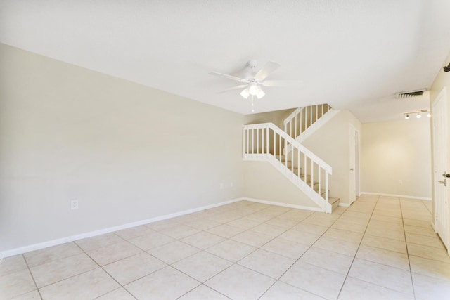 707 7th Ter, Palm Beach Gardens, FL 33418 - empty room with stairway, a ceiling fan, light tile patterned floors, and baseboards