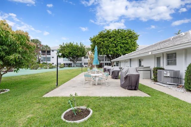 2050 NE 39th St Unit 110S, Lighthouse Point, FL 33064 - view of green lawn with central air condition unit and a patio area