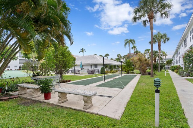 2050 NE 39th St Unit 110S, Lighthouse Point, FL 33064 - surrounding community featuring shuffleboard and a lawn
