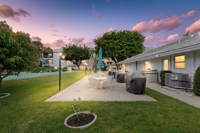 2050 NE 39th St Unit 110S, Lighthouse Point, FL 33064 - view of grassy yard with central AC and a patio