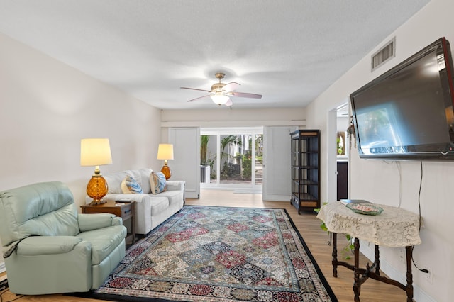 2050 NE 39th St Unit 110S, Lighthouse Point, FL 33064 - living room with a ceiling fan, light wood-type flooring, and baseboards