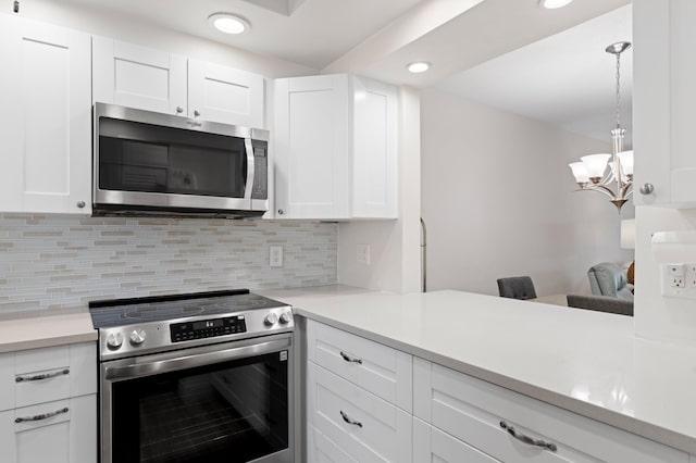 2050 NE 39th St Unit 110S, Lighthouse Point, FL 33064 - kitchen with appliances with stainless steel finishes, recessed lighting, white cabinets, decorative backsplash, and light countertops