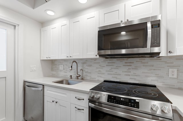 2050 NE 39th St Unit 110S, Lighthouse Point, FL 33064 - kitchen featuring appliances with stainless steel finishes, a sink, light countertops, white cabinetry, and recessed lighting