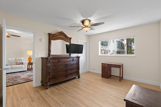 2050 NE 39th St Unit 110S, Lighthouse Point, FL 33064 - bedroom with light wood finished floors, baseboards, and ceiling fan