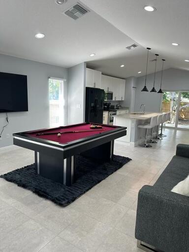 723 20th St, West Palm Beach, FL 33407 - game room with billiards table, recessed lighting, a sink, lofted ceiling, and baseboards