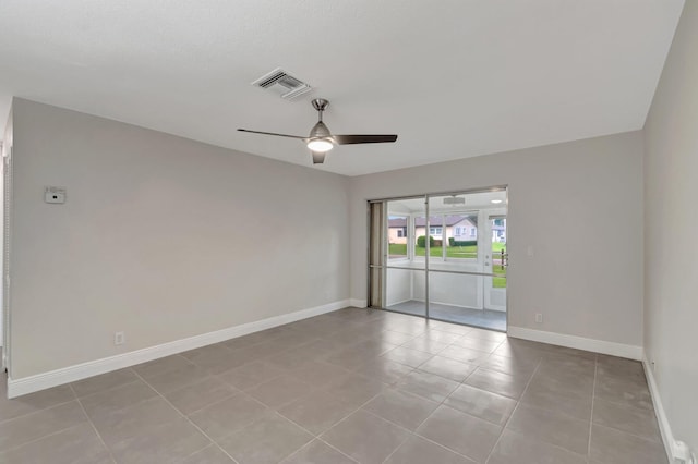 unfurnished room featuring a ceiling fan, baseboards, and light tile patterned floors