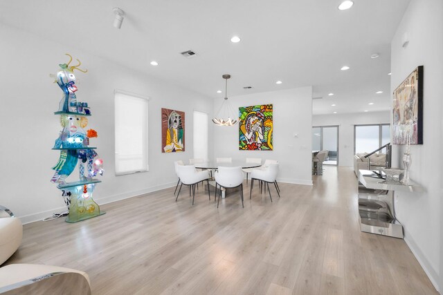 13444 Bernoulli Way, Palm Beach Gardens, FL 33418 - dining area featuring recessed lighting, light wood-style flooring, and baseboards