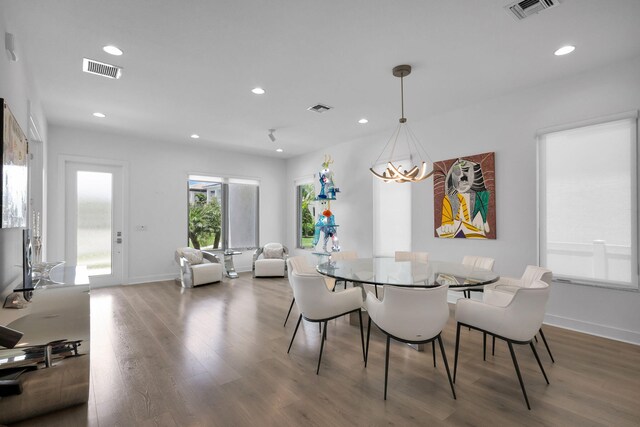 13444 Bernoulli Way, Palm Beach Gardens, FL 33418 - dining area with wood finished floors, recessed lighting, and baseboards
