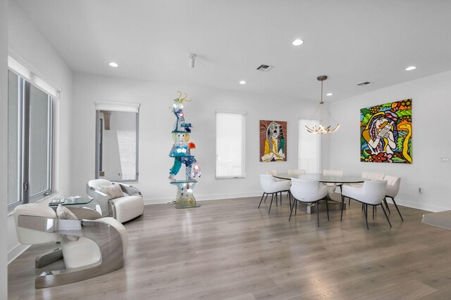 13444 Bernoulli Way, Palm Beach Gardens, FL 33418 - dining space featuring recessed lighting, wood finished floors, and baseboards