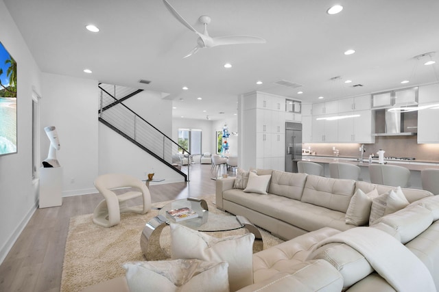 13444 Bernoulli Way, Palm Beach Gardens, FL 33418 - living area with recessed lighting, light wood finished floors, baseboards, stairway, and a ceiling fan
