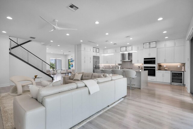 13444 Bernoulli Way, Palm Beach Gardens, FL 33418 - living room featuring beverage cooler, recessed lighting, light wood finished floors, and a ceiling fan