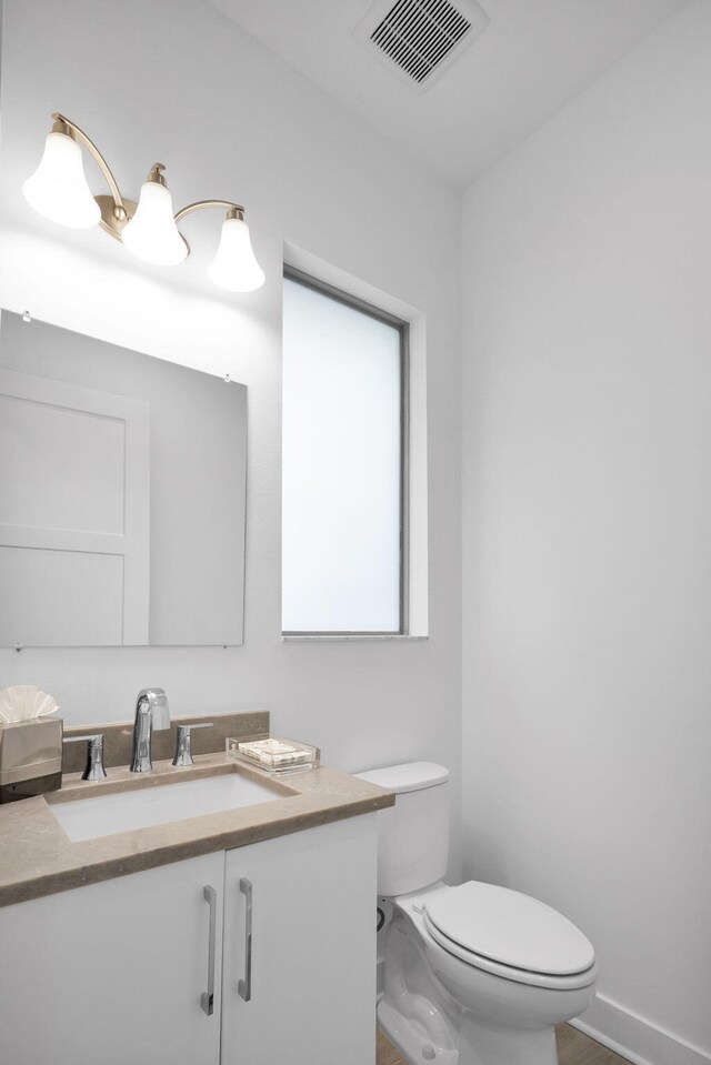 13444 Bernoulli Way, Palm Beach Gardens, FL 33418 - bathroom with toilet, vanity, and baseboards