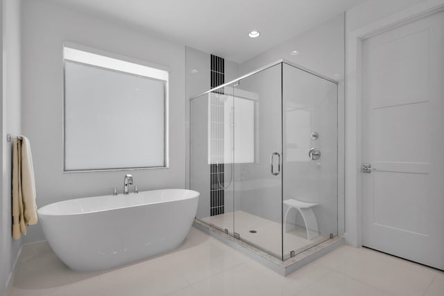 13444 Bernoulli Way, Palm Beach Gardens, FL 33418 - full bathroom featuring a soaking tub, a stall shower, tile patterned flooring, recessed lighting, and baseboards