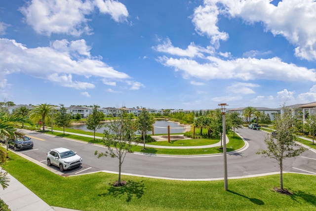 13444 Bernoulli Way, Palm Beach Gardens, FL 33418 - view of asphalt street with sidewalks, street lighting, a water view, curbs, and a residential view