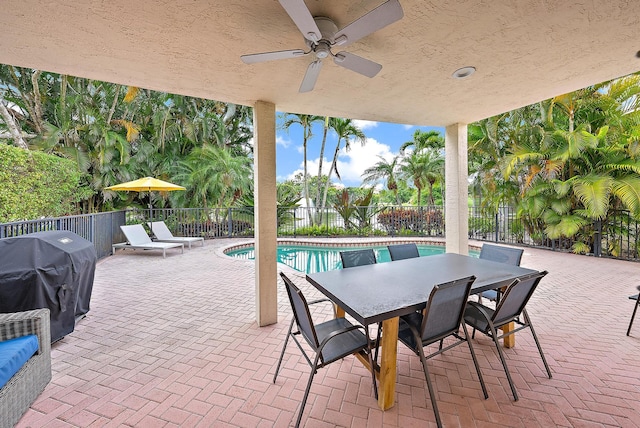 8405 Legend Club Dr, West Palm Beach, FL 33412 - fenced backyard with a grill, a patio, ceiling fan, and outdoor dining space