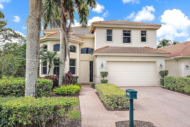 8405 Legend Club Dr, West Palm Beach, FL 33412 - mediterranean / spanish-style house featuring a tile roof, decorative driveway, a garage, and stucco siding