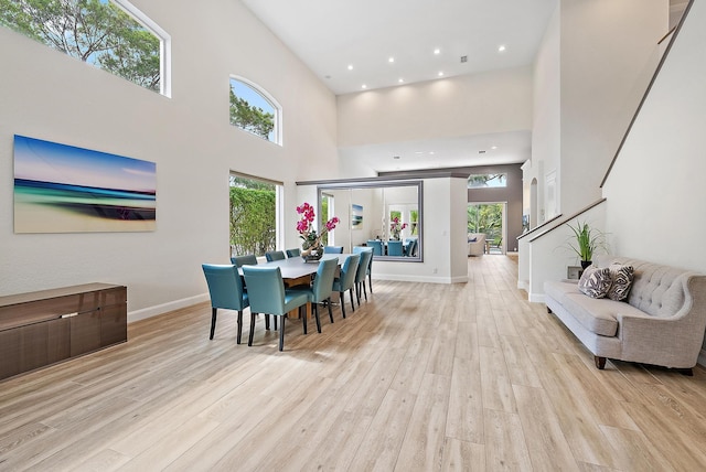 8405 Legend Club Dr, West Palm Beach, FL 33412 - dining space featuring light wood-style flooring, baseboards, a high ceiling, stairs, and recessed lighting