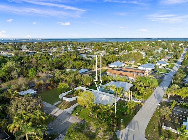 aerial overview of property's location featuring nearby suburban area and a nearby body of water