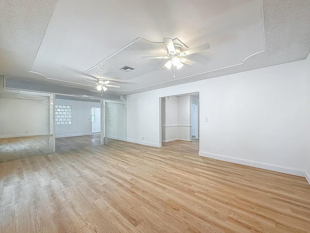 5450 Garfield Rd, Delray Beach, FL 33484 - unfurnished room with ceiling fan, light wood-style floors, baseboards, and a textured ceiling