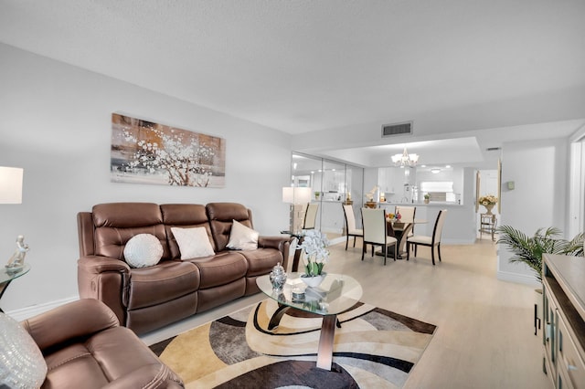 23247 Barwood Ln Unit 305, Boca Raton, FL 33428 - living area with light wood-type flooring, a chandelier, and baseboards