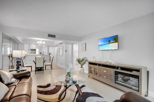23247 Barwood Ln Unit 305, Boca Raton, FL 33428 - living area with light wood-style flooring, a chandelier, and baseboards