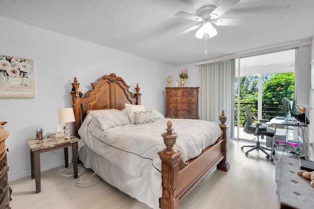 23247 Barwood Ln Unit 305, Boca Raton, FL 33428 - bedroom featuring light wood-style flooring, access to outside, a textured ceiling, a desk, and a ceiling fan