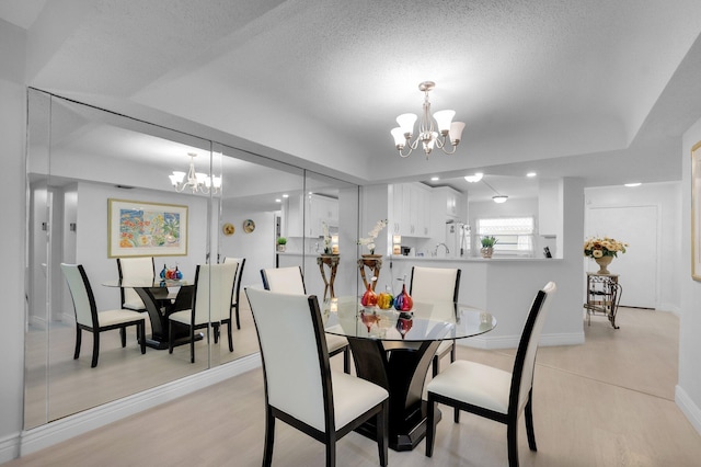 23247 Barwood Ln Unit 305, Boca Raton, FL 33428 - dining area featuring a chandelier, light wood-style flooring, and baseboards