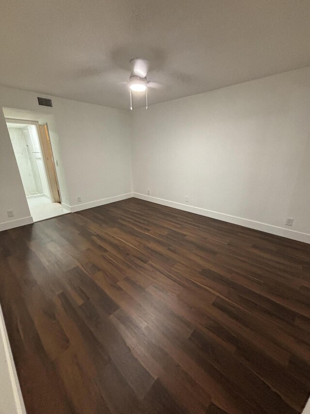 7690 Tahiti Ln Unit 102, Lake Worth, FL 33467 - unfurnished room with dark wood-style floors, baseboards, and a ceiling fan