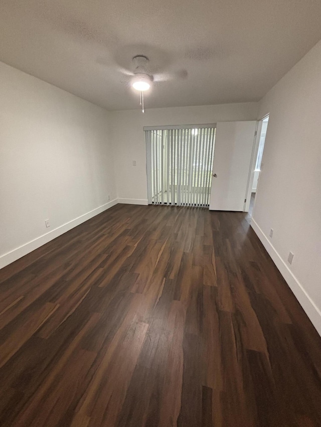 7690 Tahiti Ln Unit 102, Lake Worth, FL 33467 - unfurnished room with baseboards, dark wood-style floors, and ceiling fan