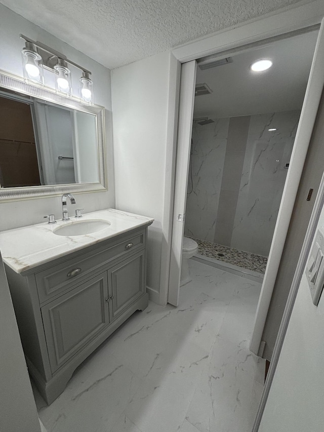 7690 Tahiti Ln Unit 102, Lake Worth, FL 33467 - full bath with a marble finish shower, vanity, marble finish floors, toilet, and a textured ceiling