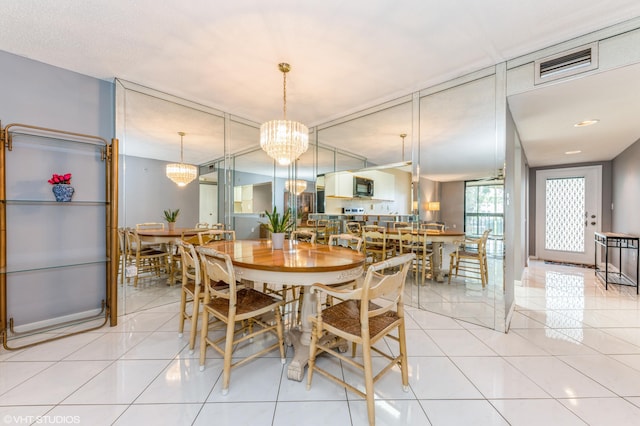 15324 Lakes Of Delray Blvd Unit 210, Delray Beach, FL 33484 - dining area with light tile patterned flooring and a chandelier