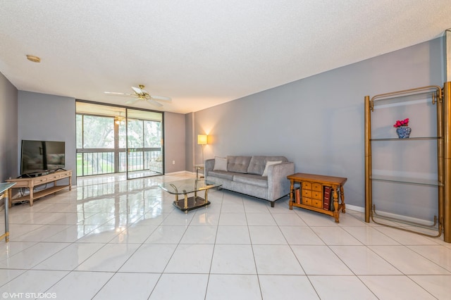 15324 Lakes Of Delray Blvd Unit 210, Delray Beach, FL 33484 - living room featuring a ceiling fan, light tile patterned floors, and a textured ceiling