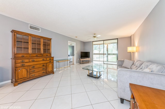 15324 Lakes Of Delray Blvd Unit 210, Delray Beach, FL 33484 - living area featuring light tile patterned flooring, ceiling fan, and a wall of windows